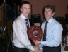 South West Antrim Chairman Leo Heatley presents captain Ciaran Mc Guckin with the SW Minor Football Shield